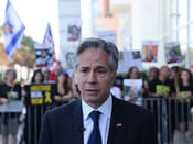 Protesters gather outside Tel Aviv hotel amid Herzog-Blinken meeting